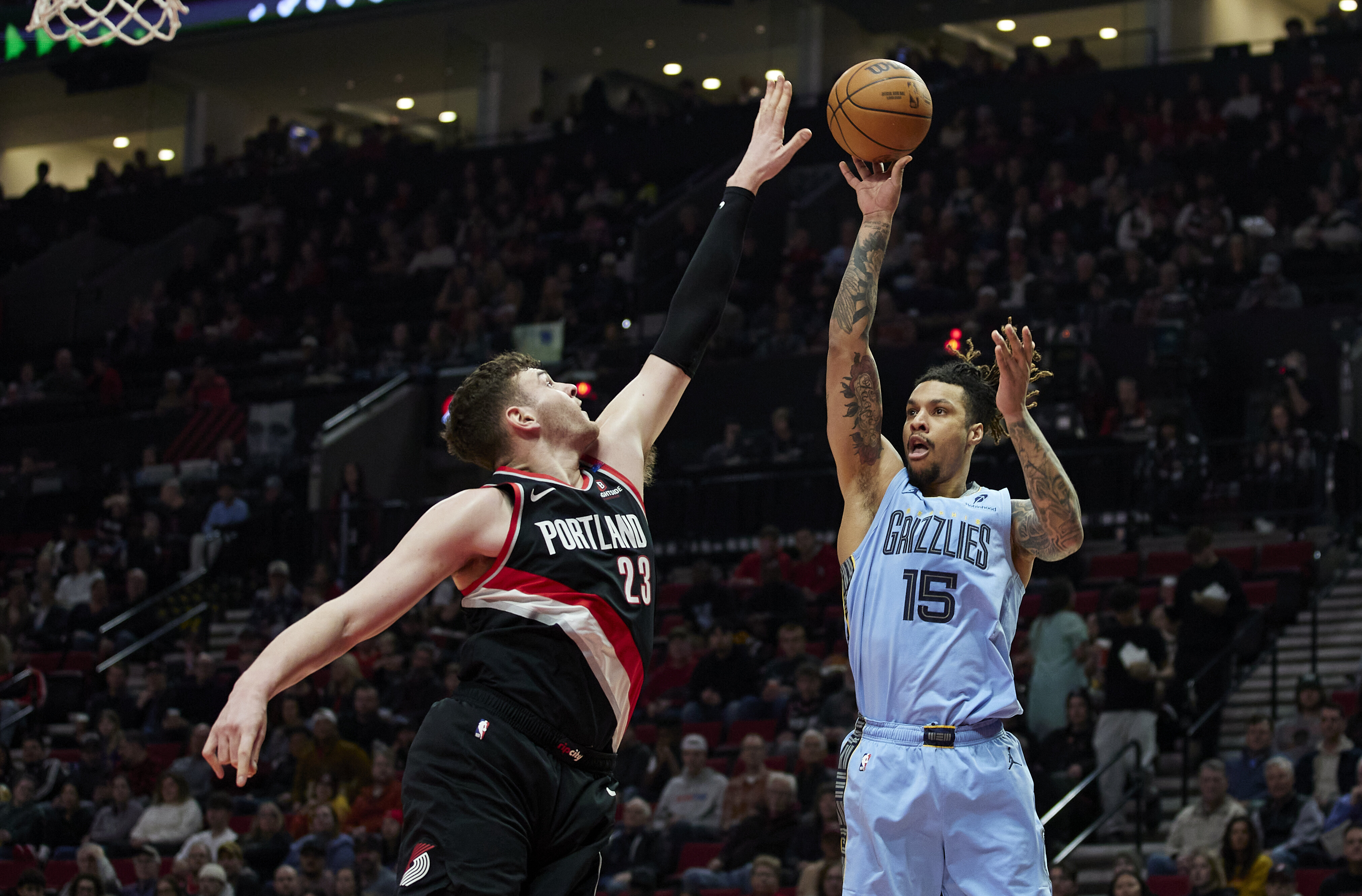Memphis Grizzlies forward Brandon Clarke, right, shoots over Portland Trail Blazers center Donovan Clingan during the first half of an NBA basketball game in Portland, Ore., Wednesday, March 19, 2025.