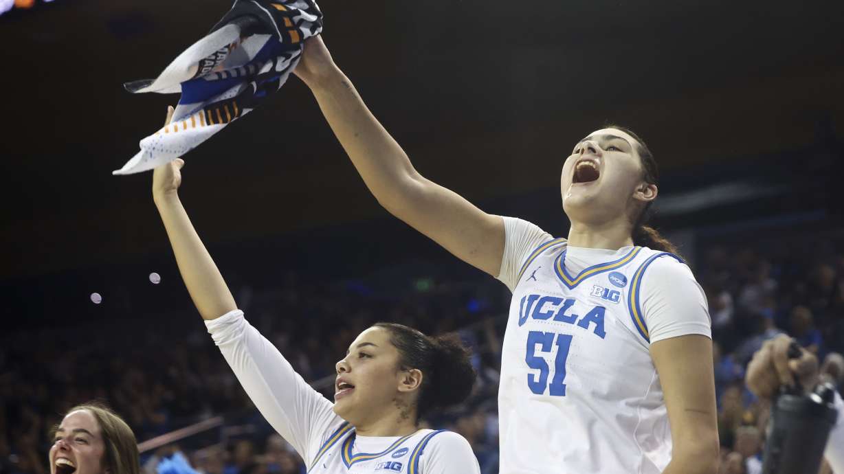 UCLA center Lauren Betts (51) and forward Timea Gardiner (30) celebrate from the bench against Southern during the second half in the first round of the NCAA college basketball tournament Friday, March 21, 2025, in Los Angeles.