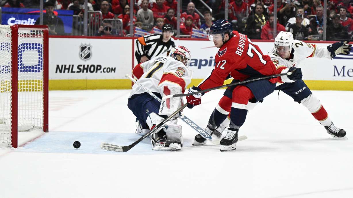 Washington Capitals left wing Anthony Beauvillier (72) scores past Florida Panthers goaltender Vitek Vanecek, front left, and defenseman Tobias Bjornfot (2) during the first period of an NHL hockey game, Saturday, March 22, 2025, in Washington.