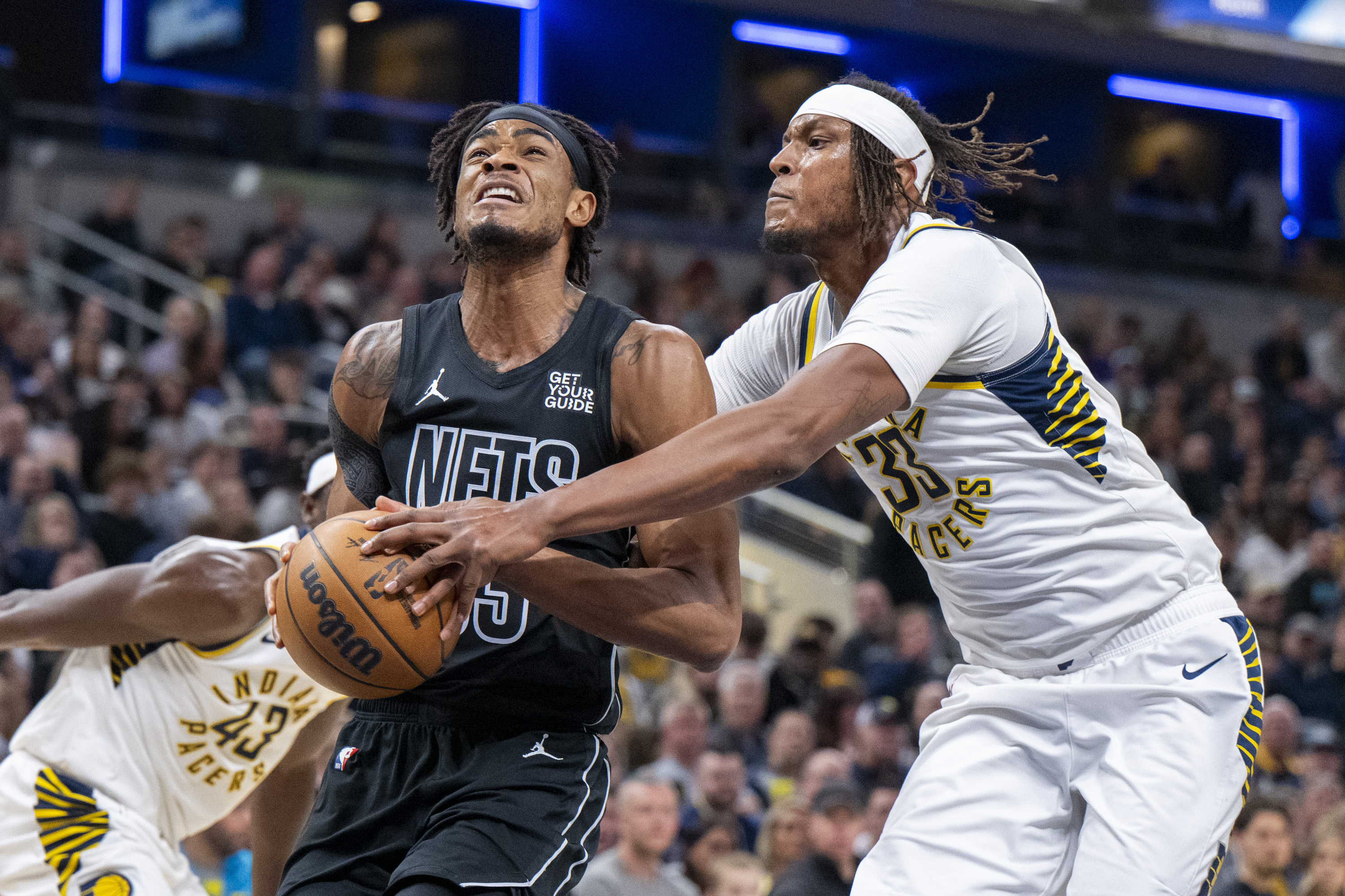 Indiana Pacers center Myles Turner (33) attempts to stop a shot by Brooklyn Nets center Nic Claxton (33) during the first half of an NBA basketball game in Indianapolis, Saturday, March 22, 2025.