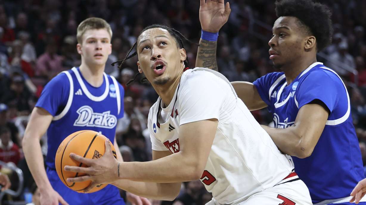 Texas Tech forward Darrion Williams (5) looks for a path to the basket against Drake guard Tavion Banks, right, during the first half in the second round of the NCAA college basketball tournament, Saturday, March 22, 2025, in Wichita, Kan.