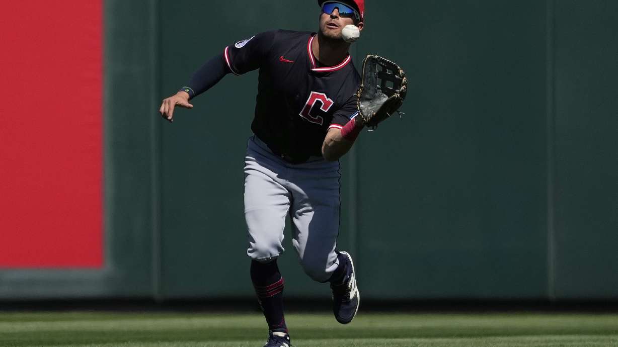 Cleveland Guardians' Tyler Freeman catches a fly out hit by Los Angeles Angels' Mike Trout during the first inning of a spring training baseball game, Wednesday, March 19, 2025, in Tempe, Ariz.