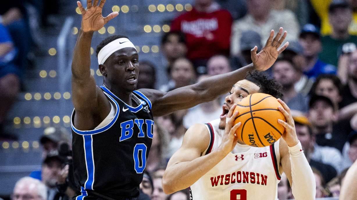BYU Cougars forward Mawot Mag (0) guards Wisconsin Badgers guard John Tonje (9) during a second-round college basketball game in the NCAA Tournament held at Ball Arena in Denver, Colo., on Saturday, March 22, 2025.