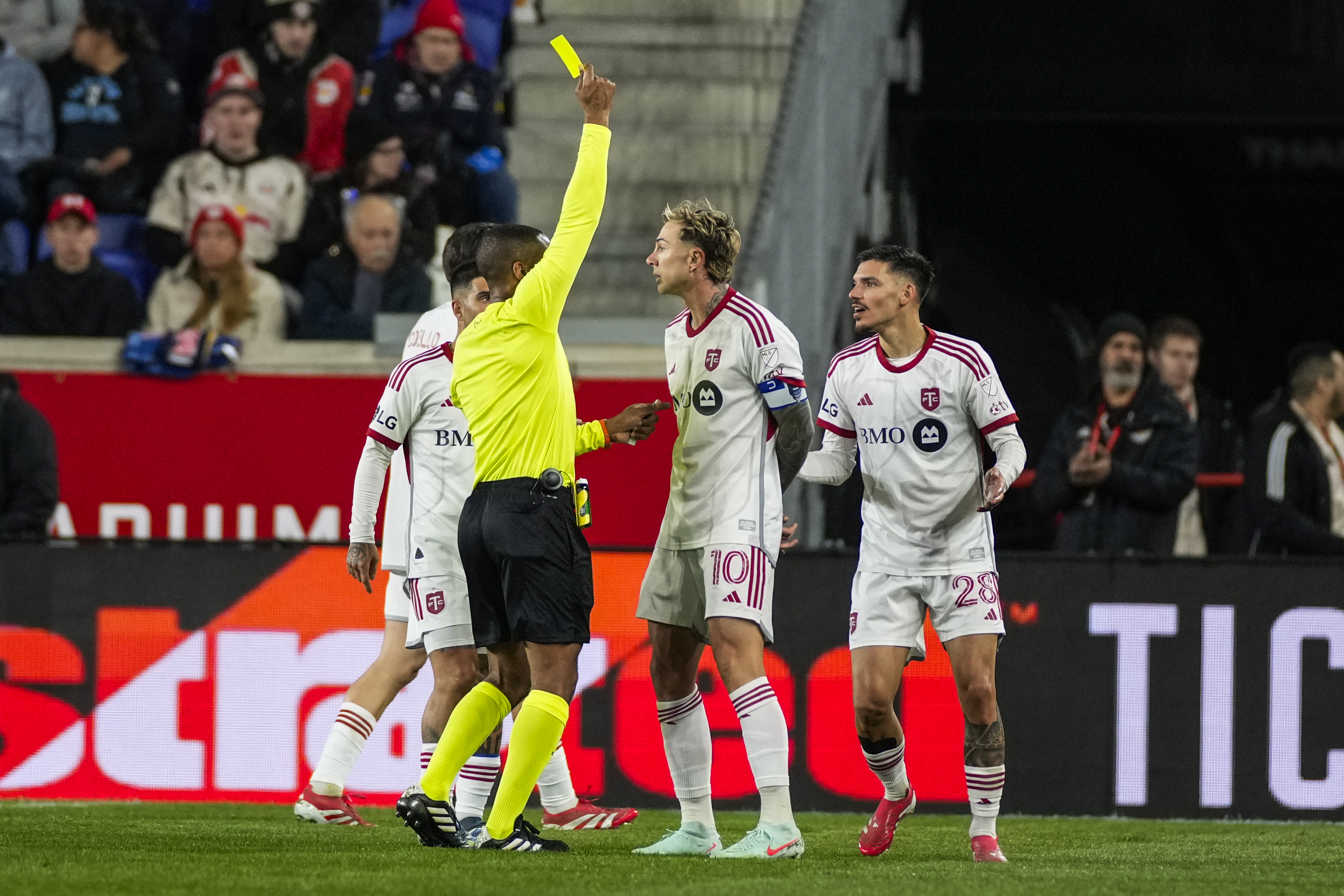 Toronto FC defender Raoul Petretta, (28) gets a yellow card during the first half of an MLS soccer match against the New York Red Bulls on Saturday, March 22, 2025, in Harrison, N.J.
