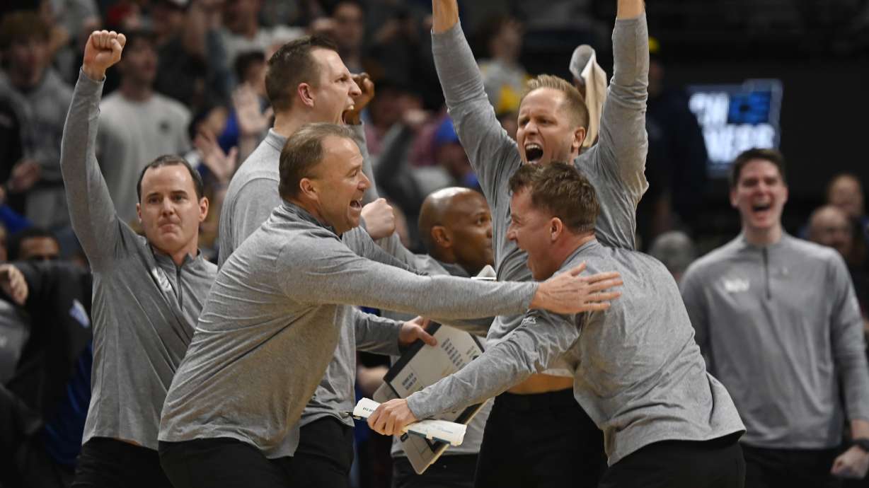 BYU head coach Kevin Young, top right, celebrates as time runs out in the second half against Wisconsin in the second round of the NCAA college basketball tournament Saturday, March 22, 2025, in Denver.