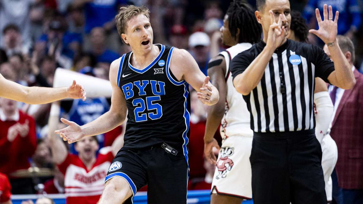 BYU Cougars guard Dawson Baker (25) reacts to a referee’s call during a second-round college basketball game in the NCAA Tournament against the Wisconsin Badgers at Ball Arena in Denver, Colo., on Saturday.