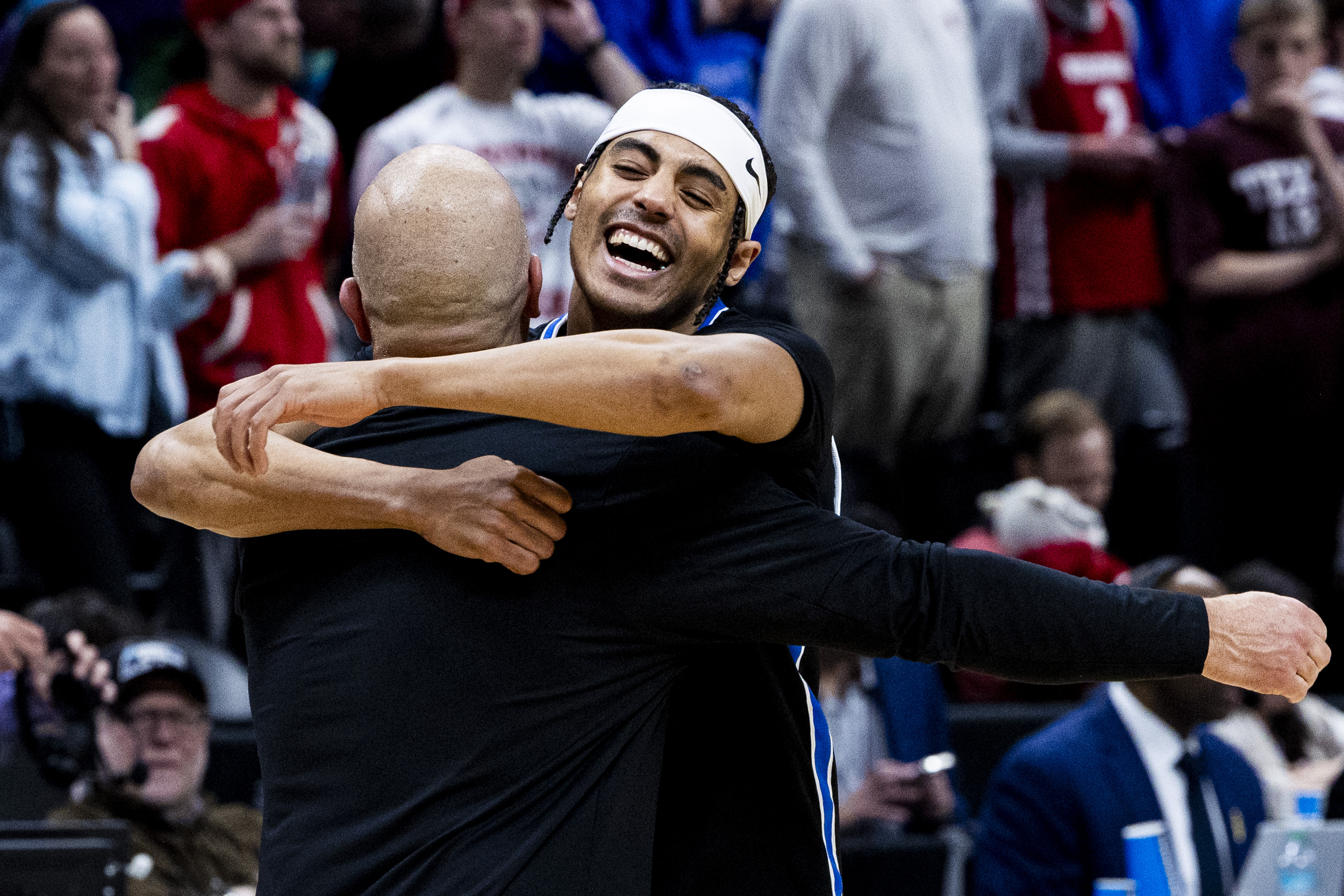 Byu Cougars will defend Trey Stewart, who hugged Cougars voice, Greg Label, after beating the Wisconsin Badgers in a second round college basketball game held at the NCAA Tournament at the Ball Arena in Denver, Colorado on Saturday, March 22, 2025.