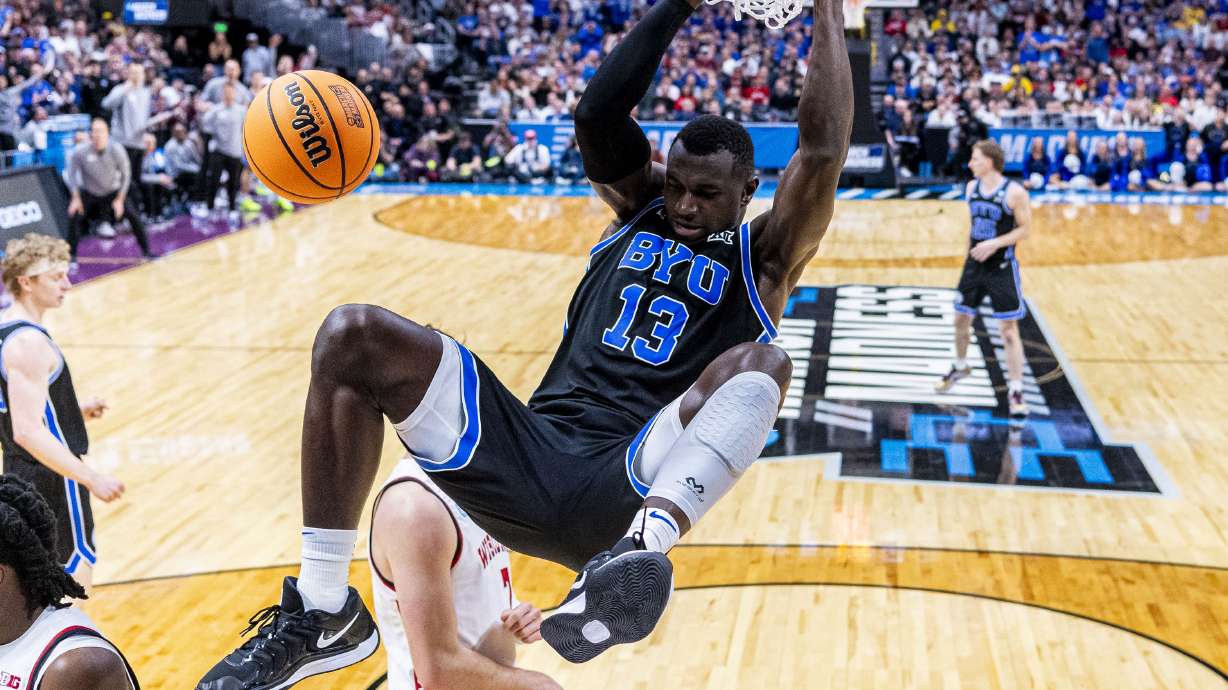 BYU Cougars center Keba Keita (13) dunks the ball against the Wisconsin Badgers during a second-round college basketball game in the NCAA Tournament held at Ball Arena in Denver, Colo., on Saturday, March 22, 2025.