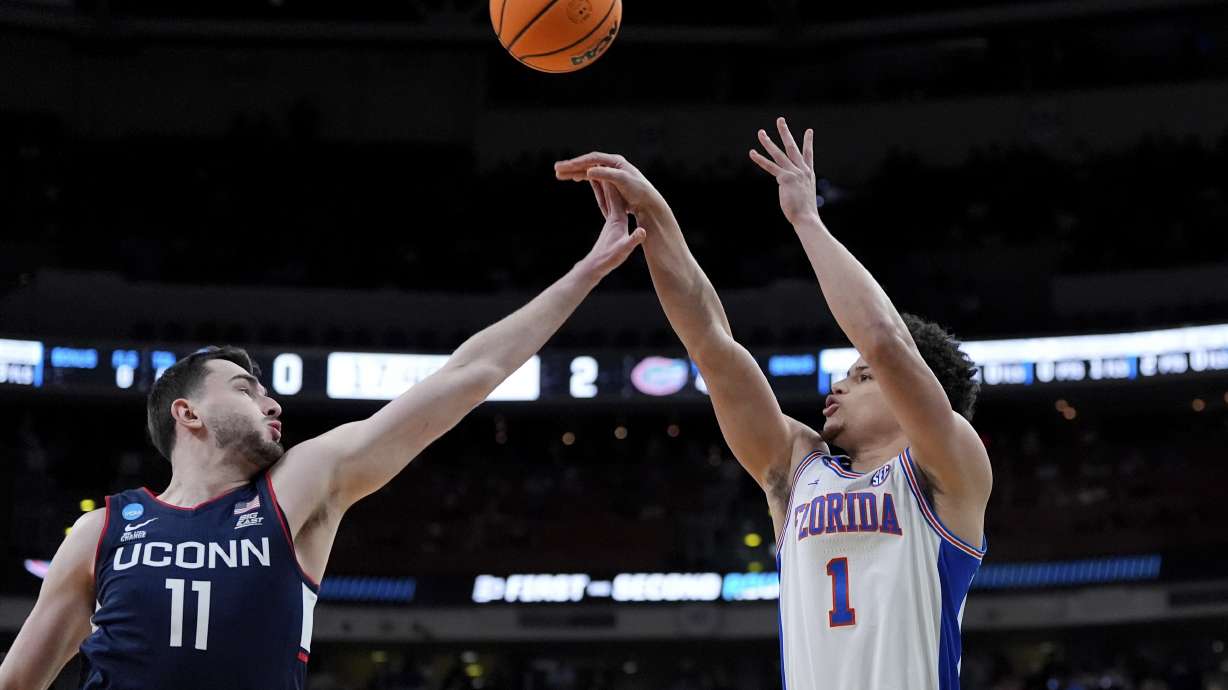Florida guard Walter Clayton Jr. (1) shoots for three in front of Connecticut forward Alex Karaban (11) during the first half in the second round of the NCAA college basketball tournament, Sunday, March 23, 2025, in Raleigh, N.C.