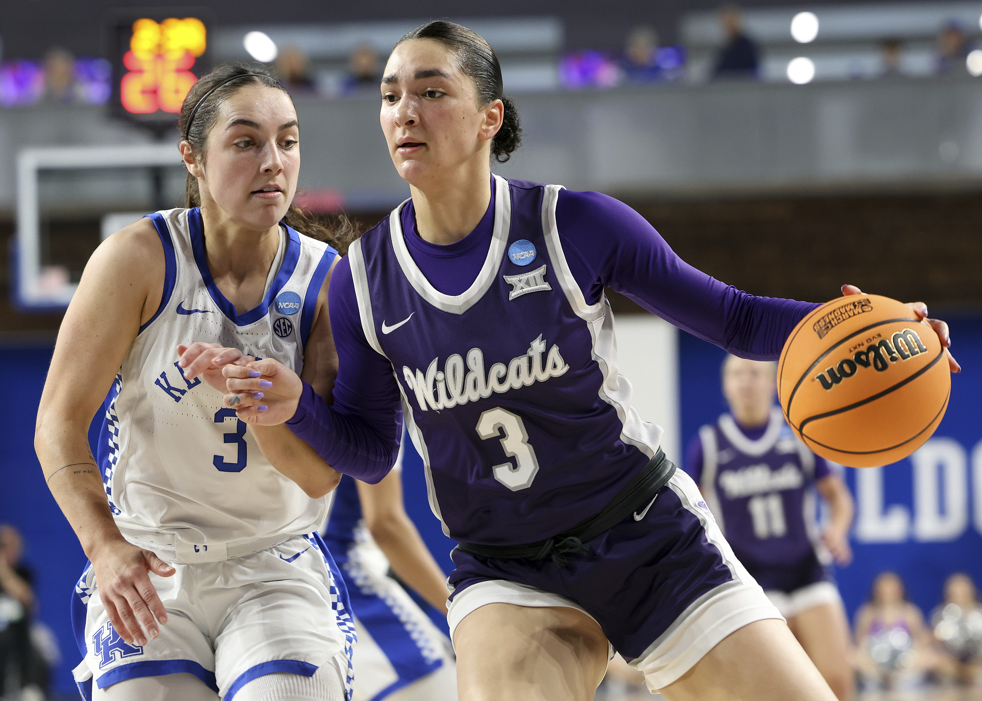 Kansas State's Jaelyn Glenn, right, drives against Kentucky's Georgia Amoore, left, in the second round of the NCAA college basketball tournament in Lexington, Ky., Sunday, March 23, 2025.