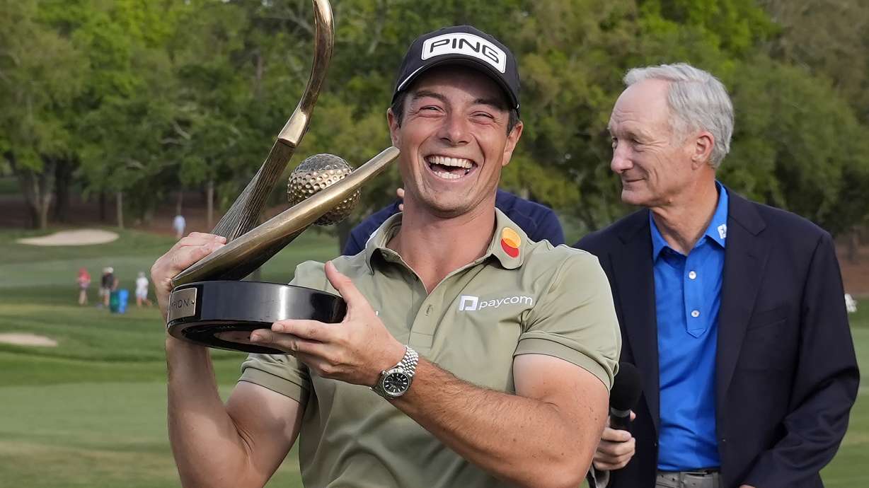 Viktor Hovland, of Norway, reacts as he hold the trophy after winning the Valspar Championship golf tournament Sunday, March 23, 2025, at Innisbrook in Palm Harbor, Fla.