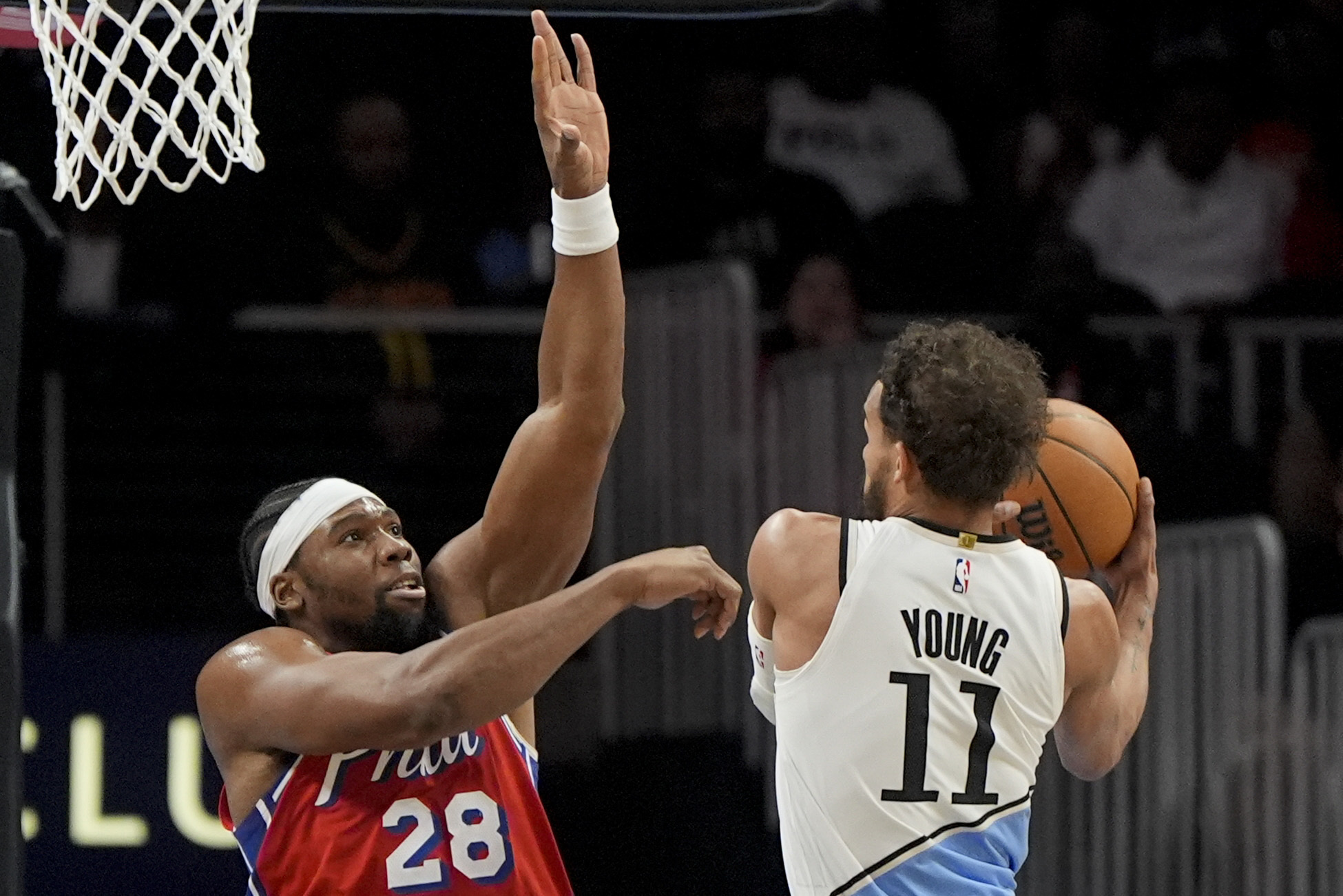 Atlanta Hawks guard Trae Young (11) shoots against Philadelphia 76ers forward Guerschon Yabusele (28) during the first half of an NBA basketball game, Sunday, March 23, 2025, in Atlanta.
