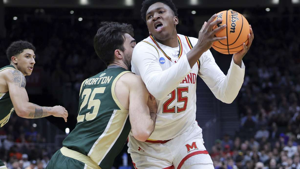 Maryland center Derik Queen, right, drives against Colorado State guard Ethan Morton during the first half in the second round of the NCAA college basketball tournament, Sunday, March 23, 2025, in Seattle.