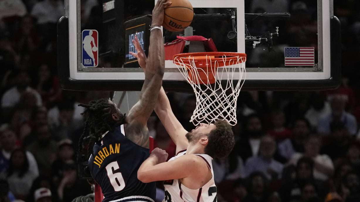 Denver Nuggets center DeAndre Jordan (6) dunks against Houston Rockets center Alperen Sengun (28) during the second half of an NBA basketball game in Houston, Sunday, March 23, 2025.
