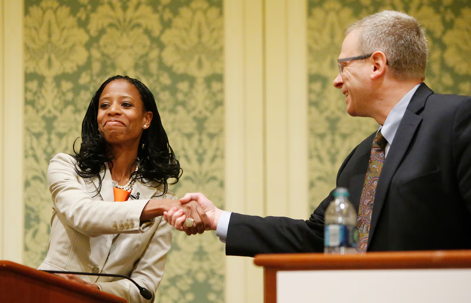 Fourth Congressional District candidates, Republican Mia Love and Democrat Doug Owens, shake hands after a debate during the 36th Annual Utah Taxes Now Conference in Salt Lake City, May 20, 2014.