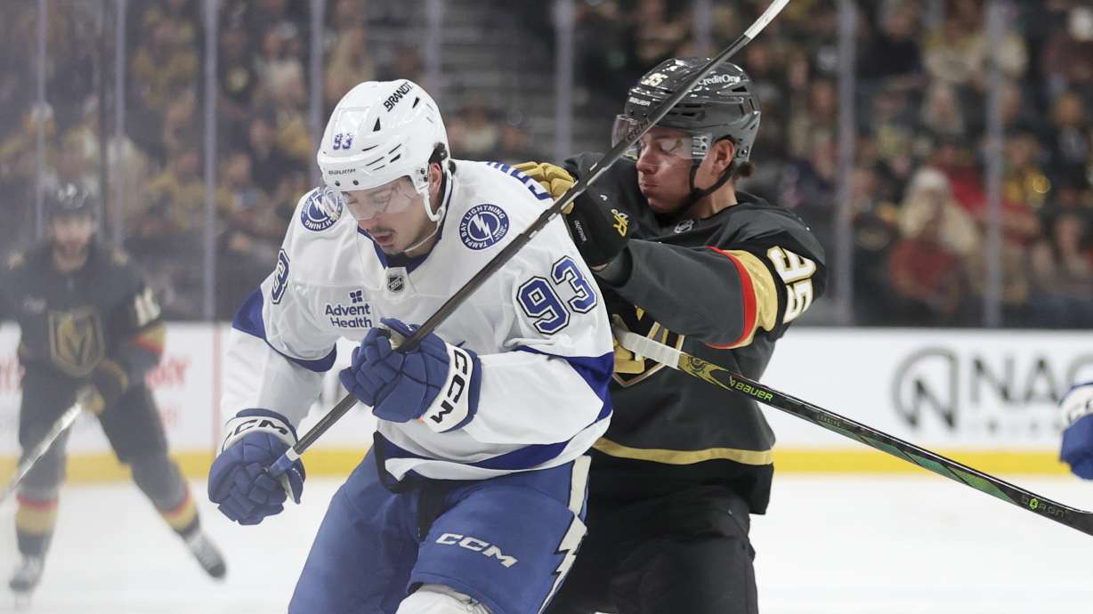 Vegas Golden Knights right wing Victor Olofsson (95) pushes Tampa Bay Lightning center Gage Goncalves (93) during the first period of an NHL hockey game Sunday, March 23, 2025, in Las Vegas.