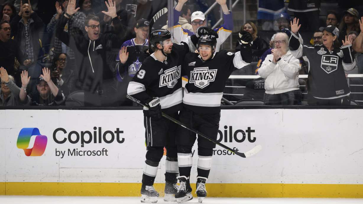 Los Angeles Kings left wing Andrei Kuzmenko, right, reacts after scoring a goal during the second period of an NHL hockey game against the Boston Bruins, Sunday, March 23, 2025, in Los Angeles.