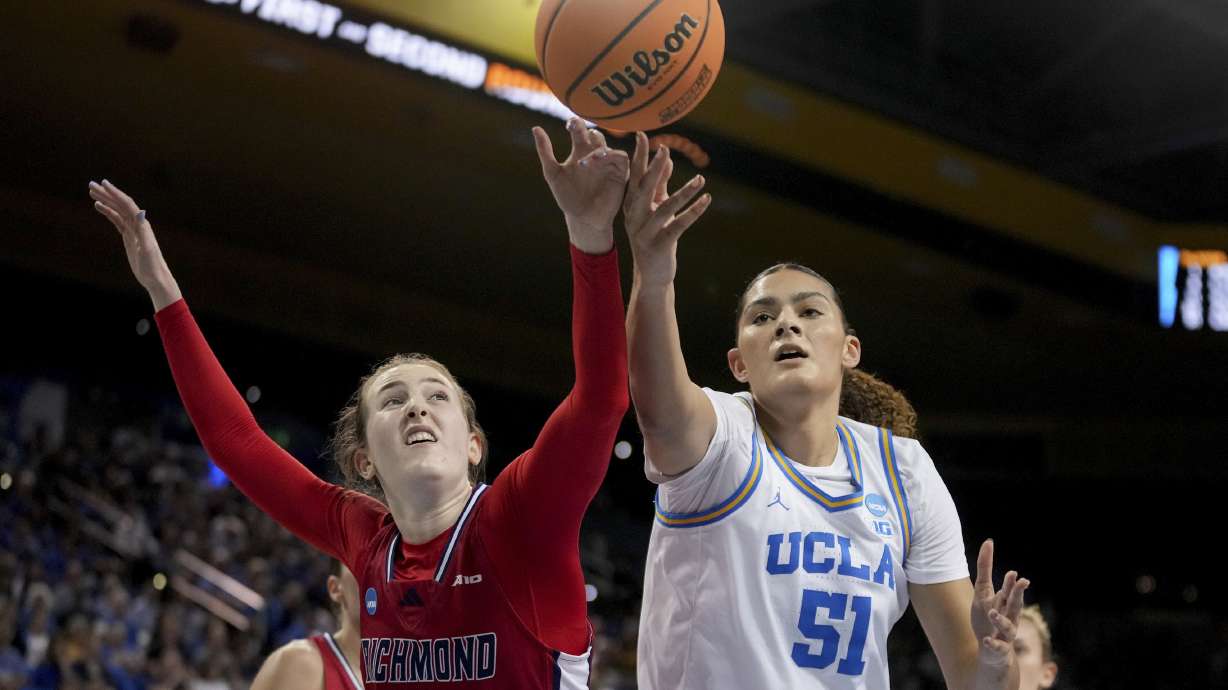 UCLA center Lauren Betts (51) and Richmond forward Maggie Doogan (44) fight for a loose ball during the first half in the second round of the NCAA college basketball tournament Sunday, March 23, 2025, in Los Angeles.