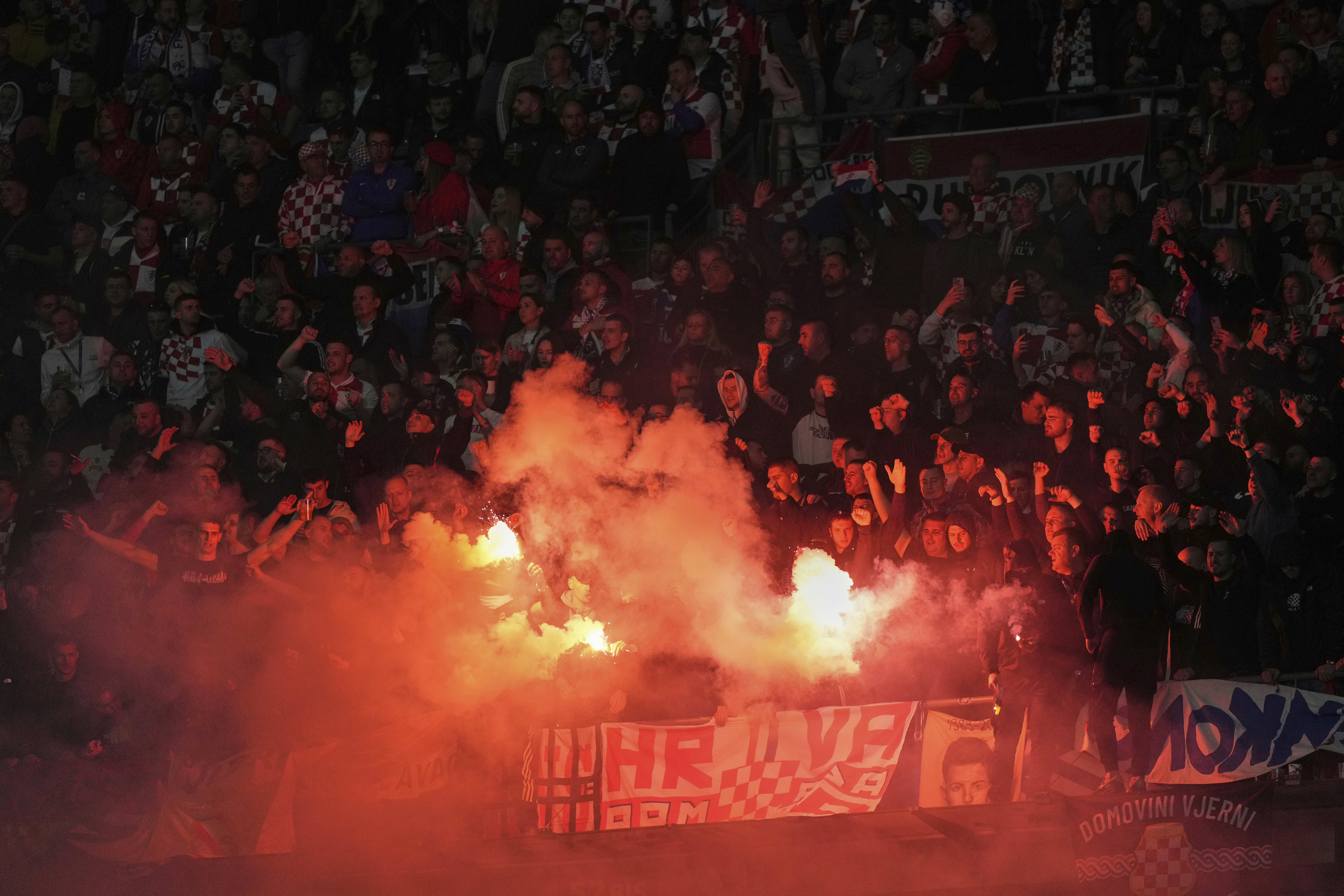 Croatia's fans light flares during the UEFA Nations League quarterfinal second leg soccer match between France and Croatia, at the Stade de France in Saint-Denis, outside Paris, Sunday, March 23, 2025.