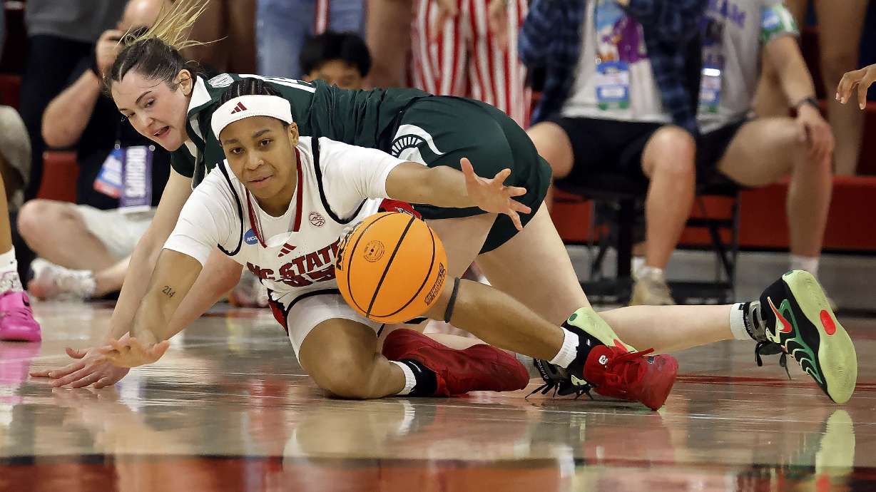 North Carolina State's Zoe Brooks (35) scrambles for the loose ball with Michigan State's Grace VanSlooten, back, during the first half in the second round of the NCAA college basketball tournament in Raleigh, N.C., Monday, March 24, 2025.