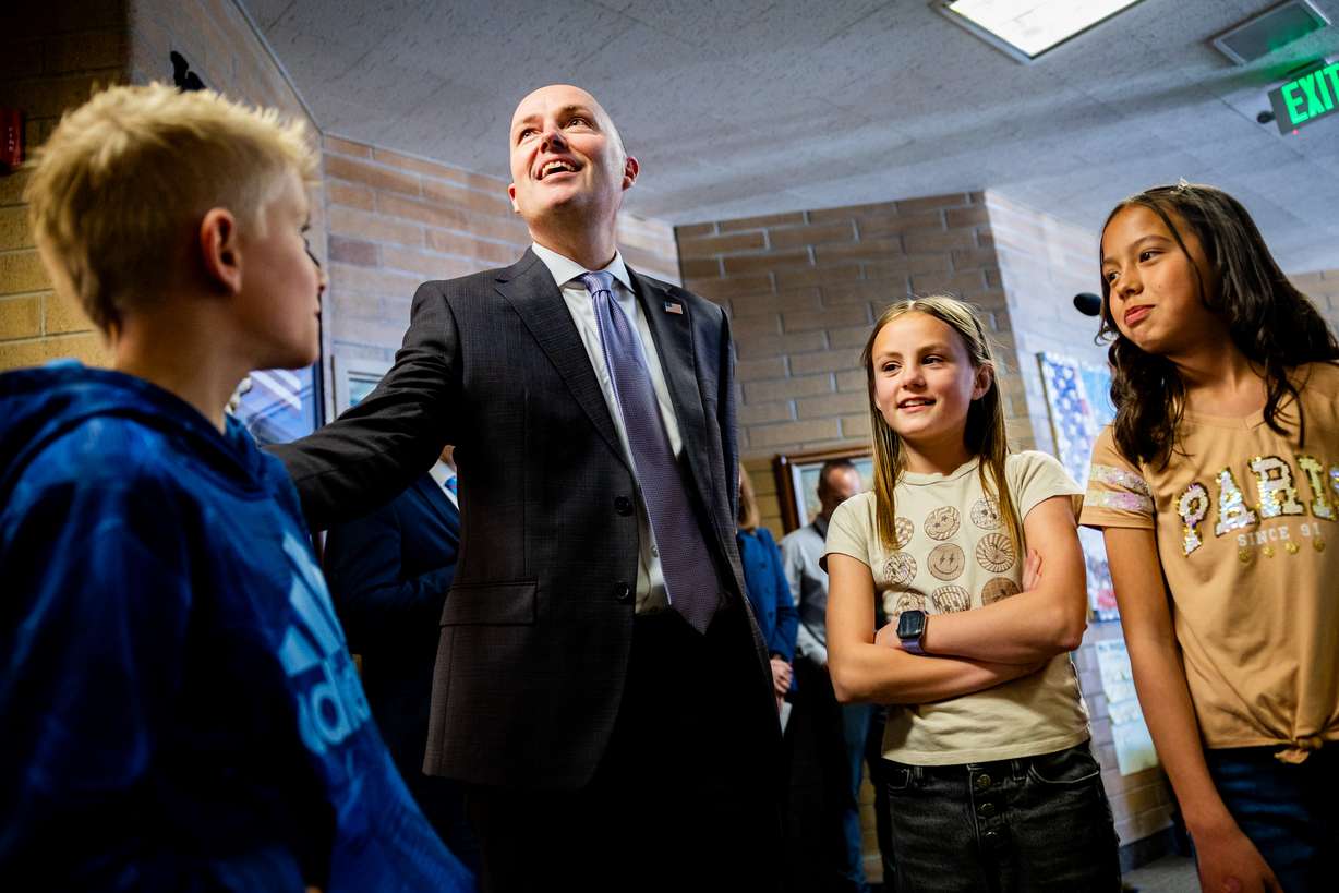 Gov. Spencer Cox greets students as he arrives for a press conference to support Utah’s rural schools where he signs HB396, which amends the formula for necessarily existent small schools funding, at Manti Elementary School in Manti on Monday.