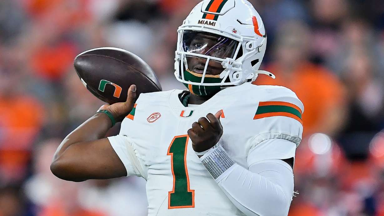 FILE - Miami quarterback Cam Ward (1) throws during the first half of an NCAA college football game against Syracuse on Saturday, Nov. 30, 2024 in Syracuse, N.Y.