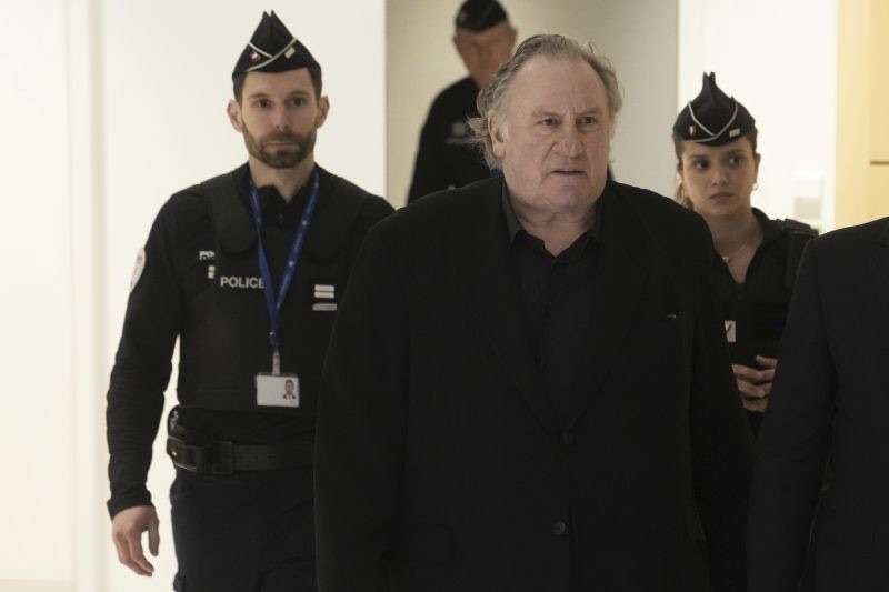 Actor Gerard Depardieu, center, who is facing trial for the alleged sexual assaults of two women on a film set in 2021, arrives Monday in Paris.