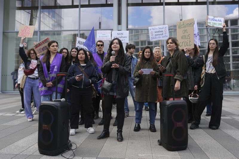 Women demonstrate outside the palace of justice where actor Gerard Depardieu faces trial for the alleged sexual assaults of two women on a film set in 2021, Monday in Paris.