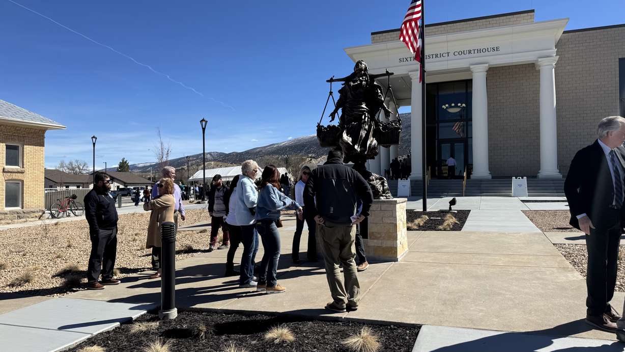 People observe a statue at the new 6th District courthouse in Manti after its dedication and ribbon-cutting ceremony on Monday.