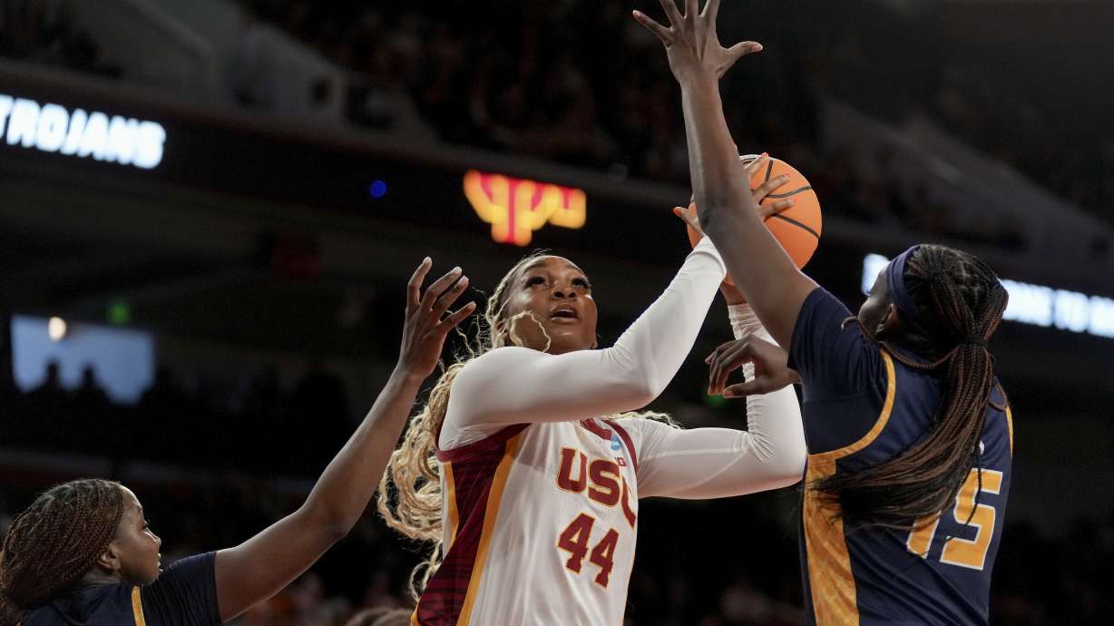 Southern California forward Kiki Iriafen (44) drives to the basket against UNC Greensboro guard Jaila Lee and forward Khalis Cain (15) during the first half in the first round of the NCAA college basketball tournament Saturday, March 22, 2025, in Los Angeles.