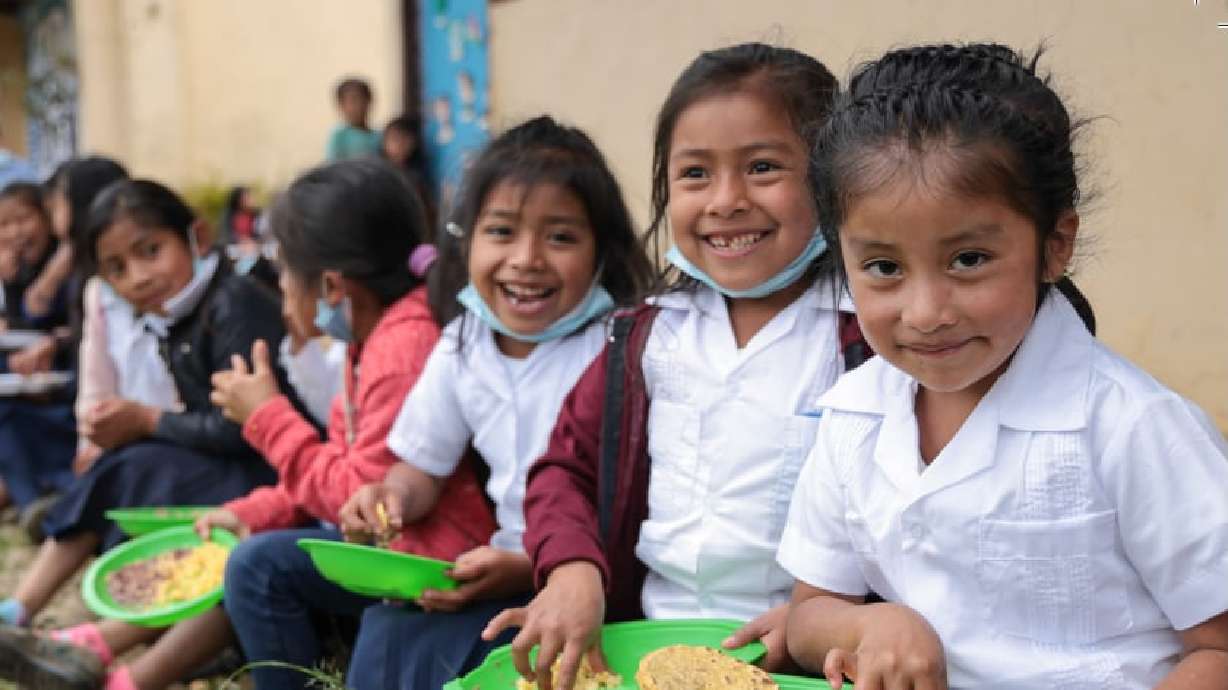 Children enjoy food provided through the annual humanitarian aid spending of The Church of Jesus Christ of Latter-day Saints. The church released its annual aid report on Tuesday.