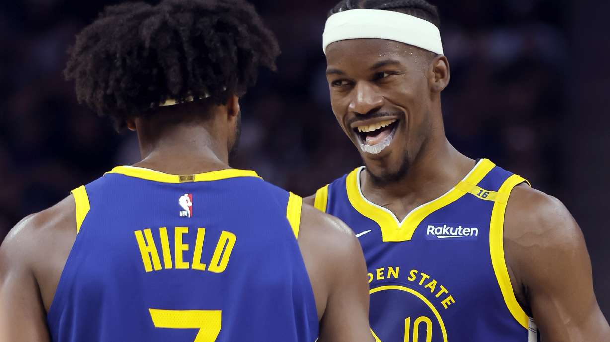 Jimmy Butler (10) celebrates with Buddy Hield (7) after he hit a desperation shot and got the foul call in the second quarter as the Golden State Warriors played the Dallas Mavericks at Chase Center in San Francisco, on Sunday, Feb. 23, 2025.
