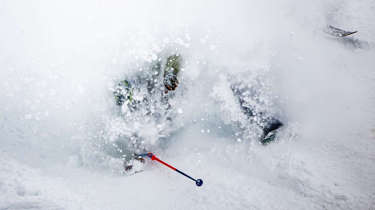A person crashes while skiing in fresh snow at Solitude Mountain Resort in Brighton on March 6. Spring doesn't mean the end of the ski and snowboard season, as resorts often see big snow in April.