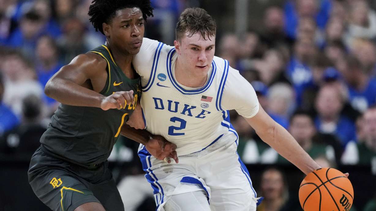 Duke forward Cooper Flagg (2) drives past Baylor guard Robert Wright III (1) during the second half in the second round of the NCAA college basketball tournament, Sunday, March 23, 2025, in Raleigh, N.C.