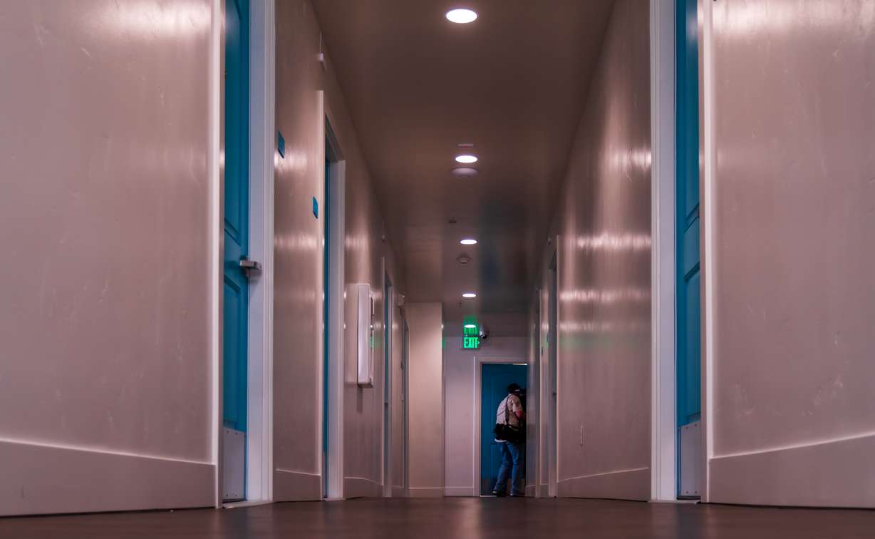 People tour the Stratford Apartments on Wednesday. The facility offers 46 permanent supportive housing units for people recovering from behavioral health conditions who have also experienced homelessness.