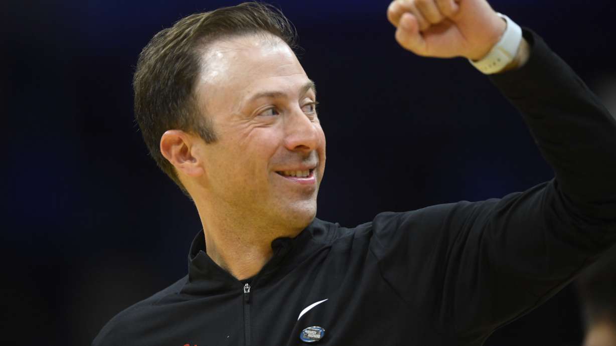 New Mexico head coach Richard Pitino celebrates a win against Marquette in the first round of the NCAA college basketball tournament, Friday, March 21, 2025, in Cleveland.