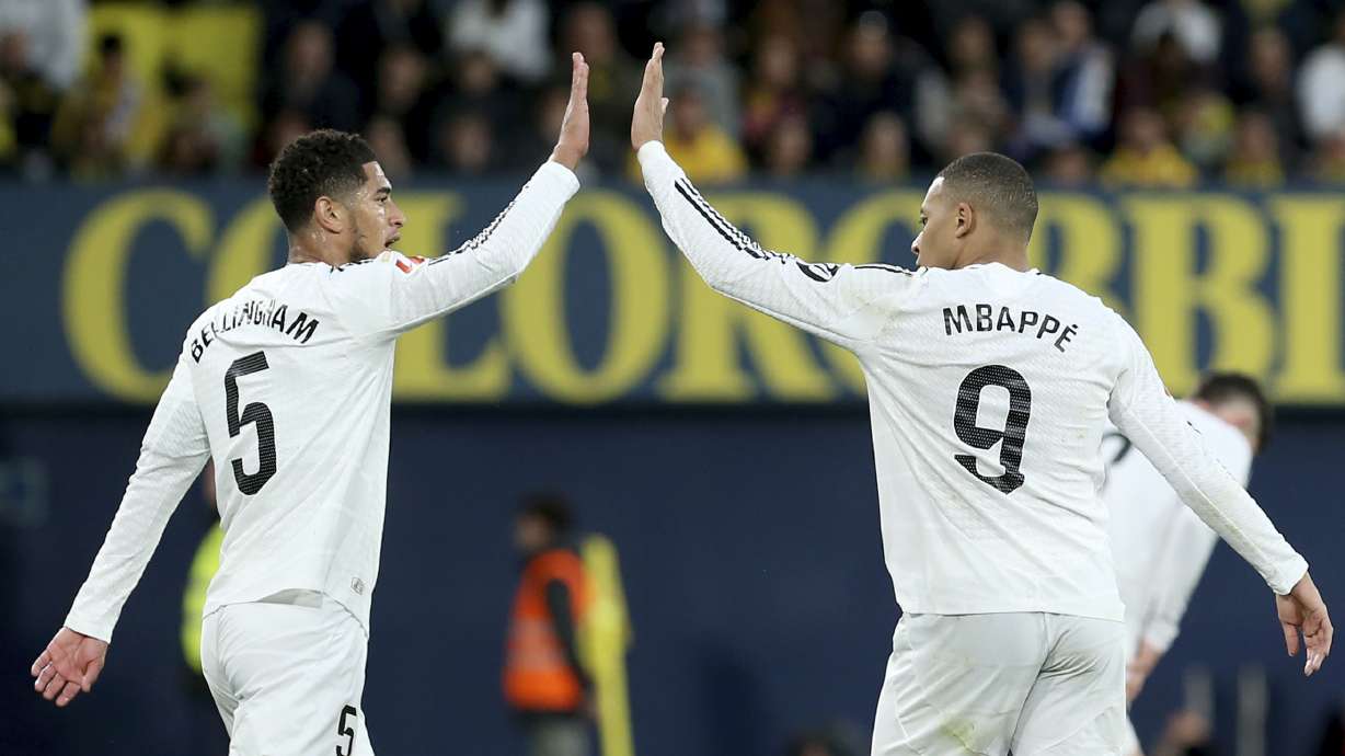 Real Madrid's Kylian Mbappe celebrates with Jude Bellingham, left, after scoring his side's second goal during a Spanish La Liga soccer match between Villarreal and Real Madrid in Villarreal, Spain, Saturday, March 15, 2025.