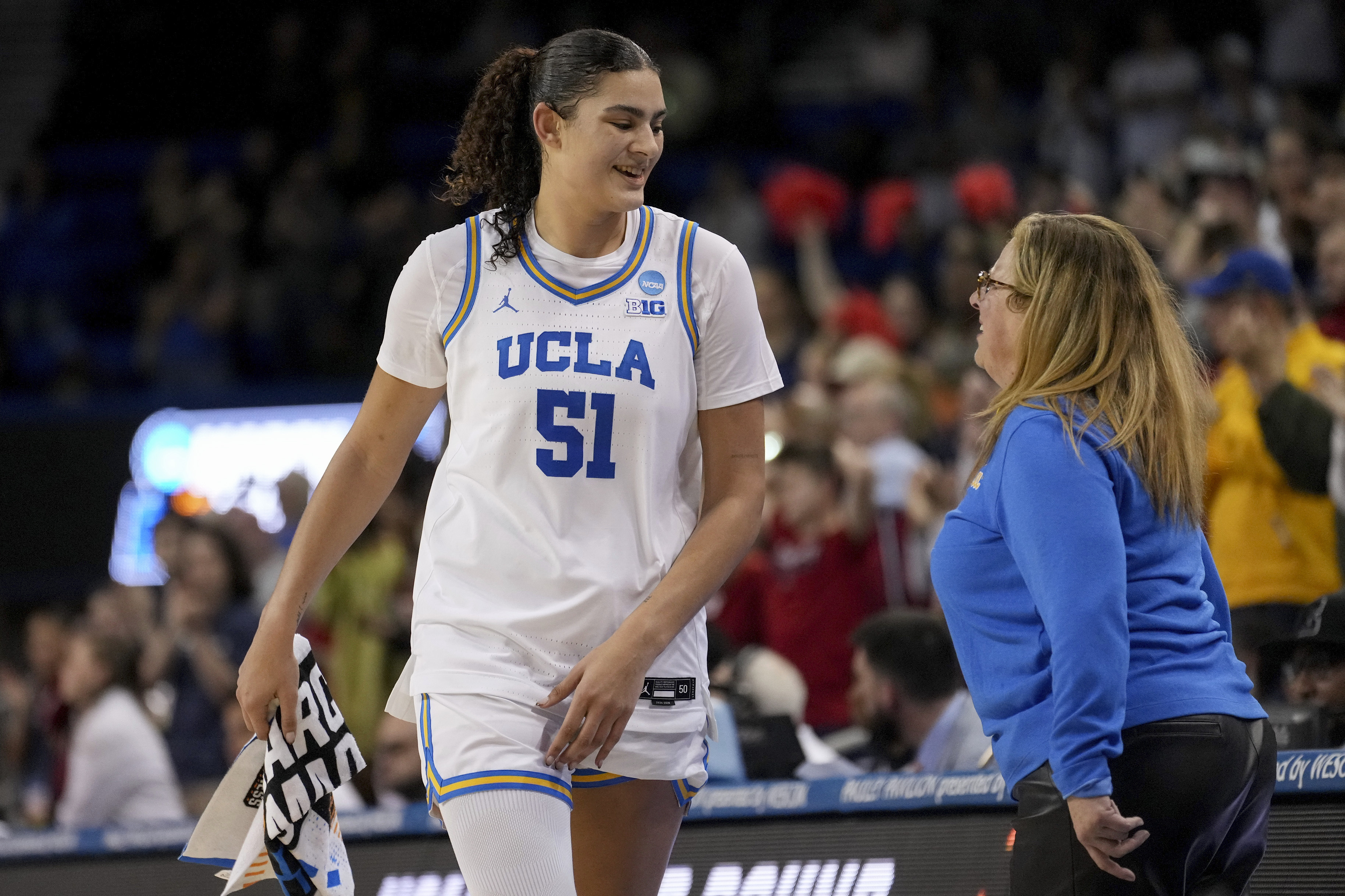 UCLA coach Cori Close talks with center Lauren Betts (51) during the second half of a game against Richmond in the second round of the NCAA college basketball tournament Sunday, March 23, 2025, in Los Angeles.