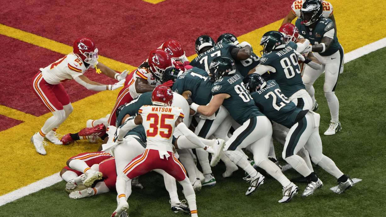 FILE - Philadelphia Eagles quarterback Jalen Hurts (1) is pushed over the goal line by teammates to a touchdown against the Kansas City Chiefs during the first half of the NFL Super Bowl 59 football game, Sunday, Feb. 9, 2025, in New Orleans.