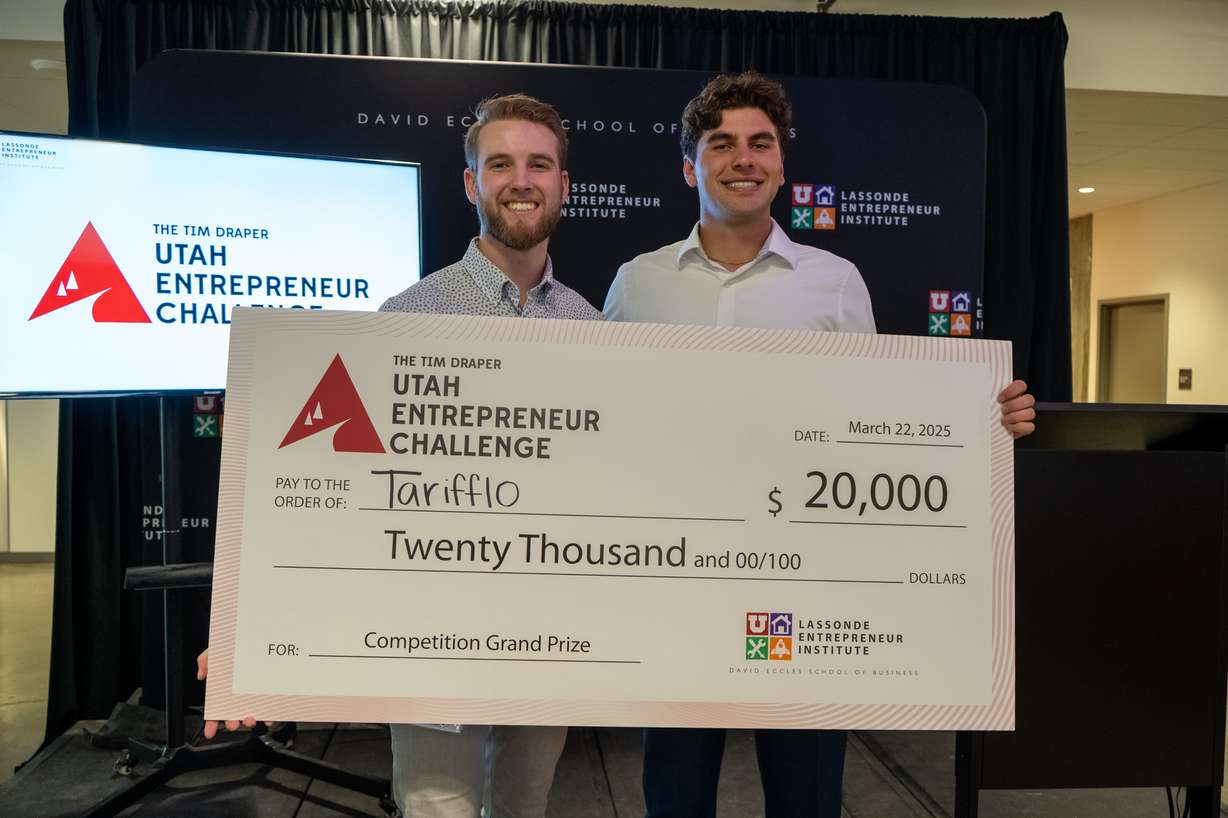 Tarifflo co-founders Tanner Helms, left, and Bryce Judy, right, receive the $20,000 grand prize at the Tim Draper Utah Entrepreneur Challenge on Saturday, March 22, 2025. Tarifflo automates international trade documentation, outperforming traditional and competing software solutions.