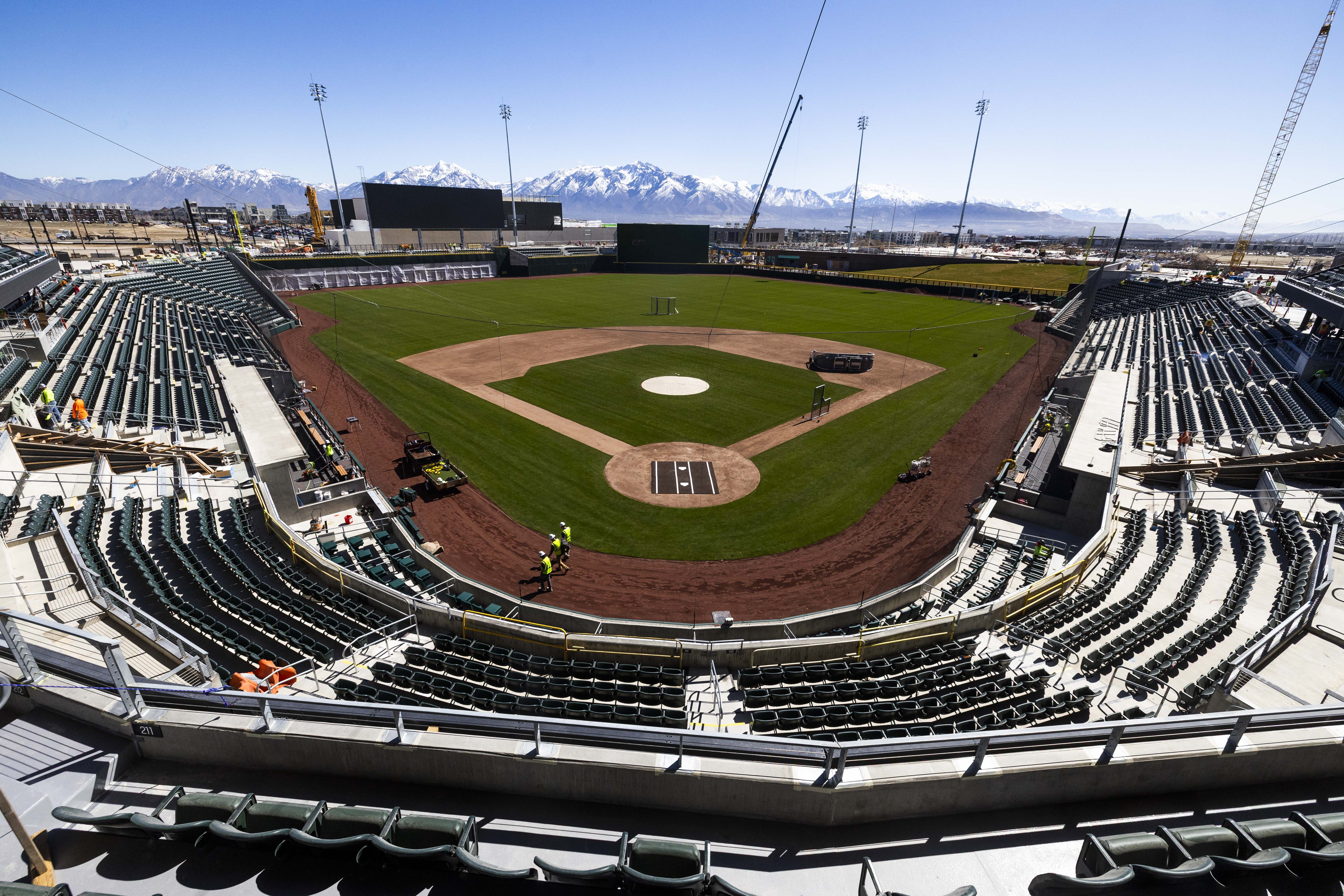 Construction workers walk on the field as they work on the Salt Lake Bees' new baseball stadium, at The Ballpark at American First Square in South Jordan on Wednesday.