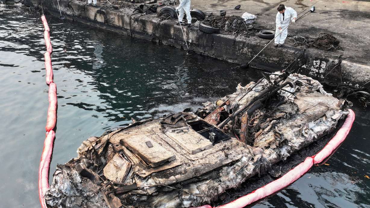 A burnt-out fishing boat is seen at a damaged port due to wildfires in Yeongdeok, South Korea, Wednesday. Twenty-six people have been killed, and more than 300 structures are already destroyed in the southern regions.