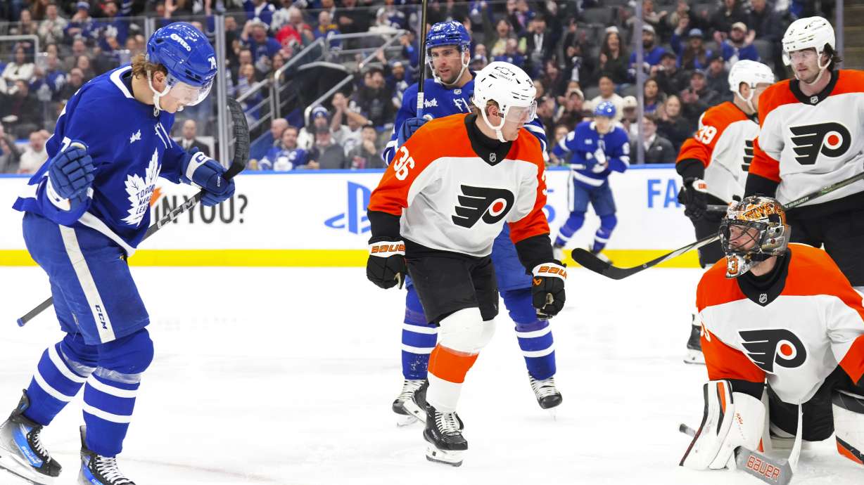 Philadelphia Flyers goaltender Samuel Ersson (33) looks up as Toronto Maple Leafs' Bobby McMann, left, celebrates scoring during second period NHL hockey action in Toronto on Tuesday, March 25, 2025.