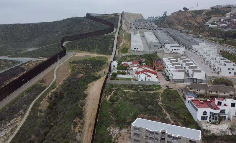 A drone image shows electronic monitoring equipment near the secondary border wall between Mexico and the United States in San Diego, Calif., as seen from Tijuana, Mexico, Tuesday.