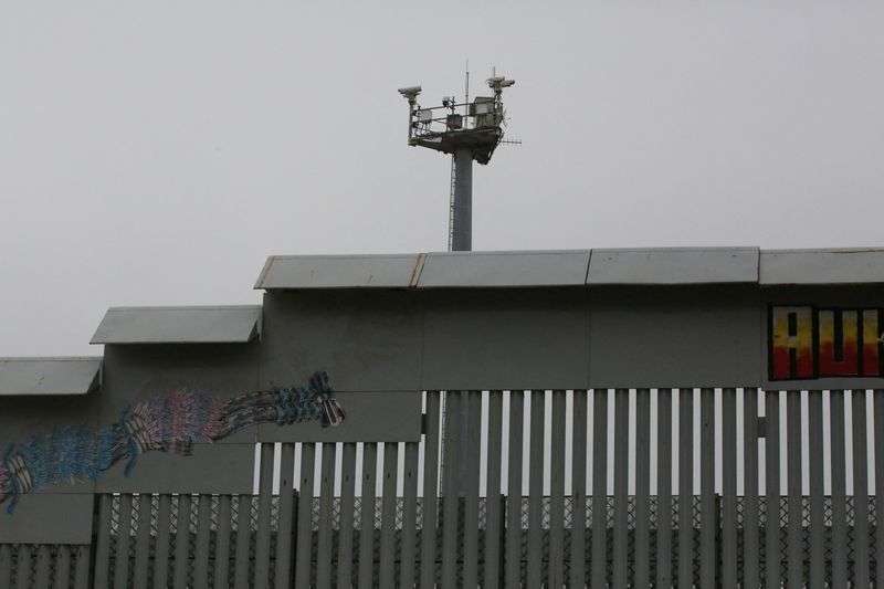 Electronic monitoring equipment stands near the secondary border wall between Mexico and the United States in San Diego, Calif., as seen from Tijuana, Mexico, Tuesday.