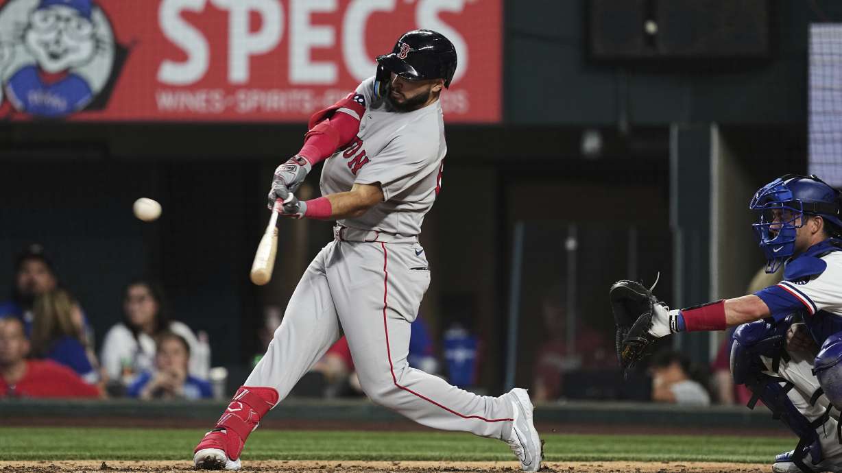 Boston Red Sox's Wilyer Abreu connects for a three-run homerun as Texas Rangers' Kyle Higashioka, right, looks on in the ninth inning of an opening-day baseball game, Thursday, March 27, 2025, in Arlington, Texas.