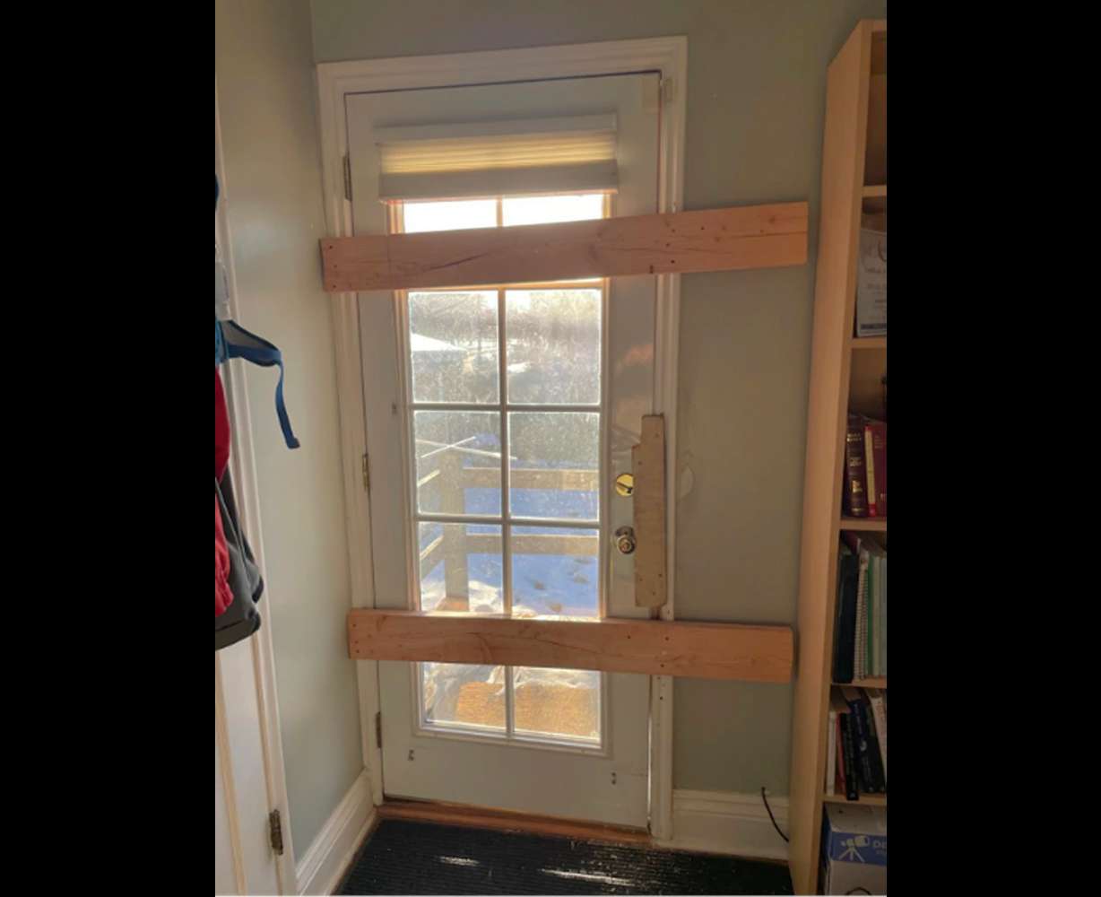 Door boarded up after stranger kicked it in.