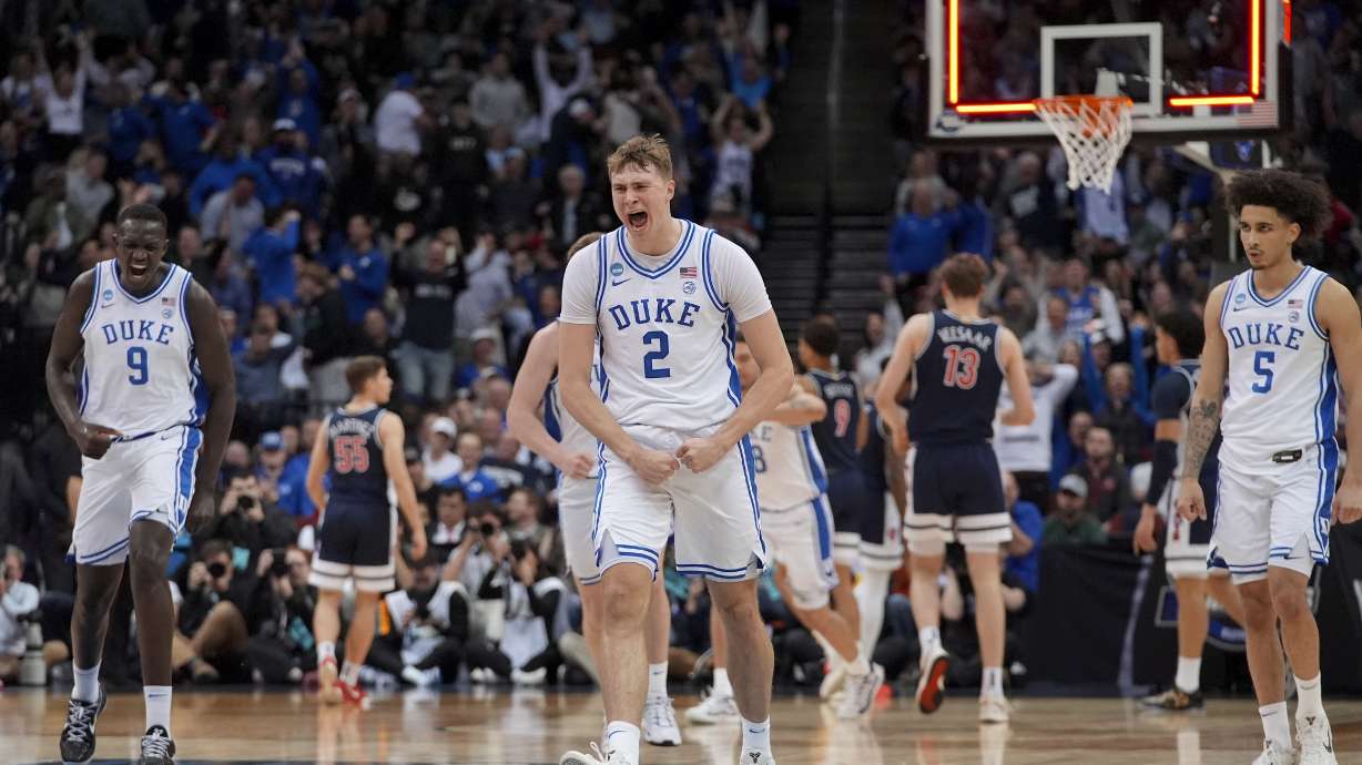 Duke forward Cooper Flagg (2) reacts after making a three point basket against Arizona to end the first half of a Sweet 16 round NCAA college basketball tournament game, Thursday, March 27, 2025, in Newark, N.J.