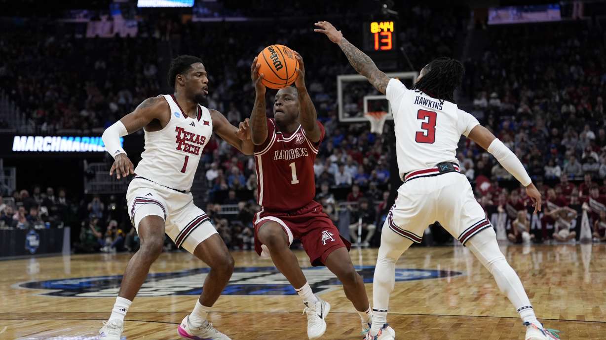 Texas Tech guard Kevin Overton (1) and guard Elijah Hawkins (3) defend against Arkansas guard Johnell Davis (1) during the first half in the Sweet 16 of the NCAA college basketball tournament, Thursday, March 27, 2025, in San Francisco.