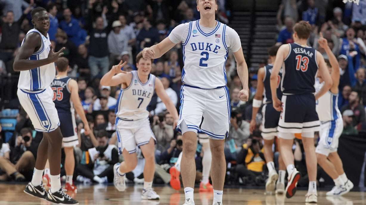 Duke forward Cooper Flagg (2) reacts after making a three point basket against Arizona to end the first half of a Sweet 16 round NCAA college basketball tournament game, Thursday, March 27, 2025, in Newark, N.J.